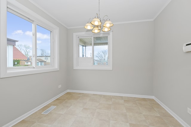 spare room with an inviting chandelier, crown molding, and a wealth of natural light