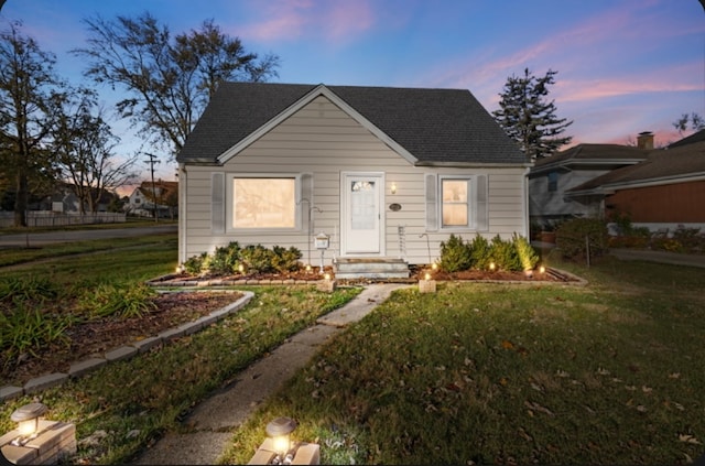 bungalow-style home featuring a yard