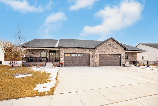 view of front of property featuring driveway, brick siding, a porch, and an attached garage