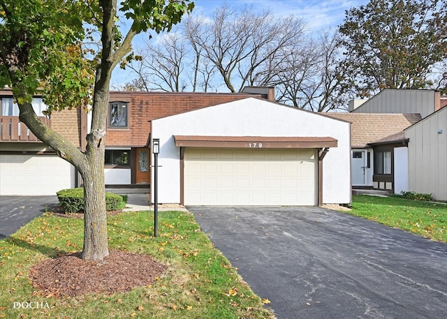 view of front facade with a front yard and a garage