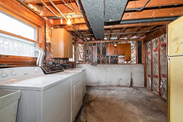 basement with separate washer and dryer and sink