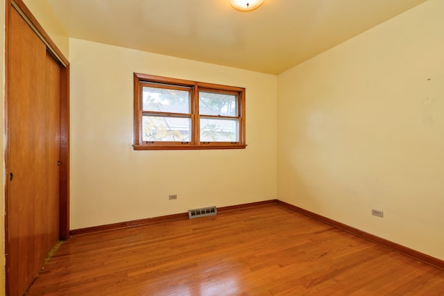 unfurnished bedroom featuring a closet and light hardwood / wood-style flooring