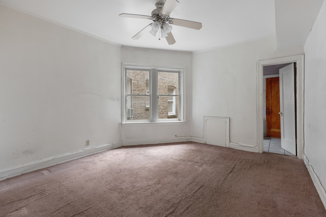 unfurnished room featuring ceiling fan, ornamental molding, and light colored carpet