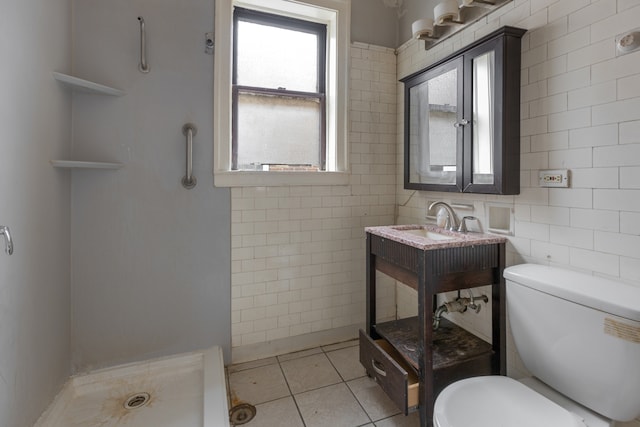 bathroom featuring toilet, a shower, tile walls, and tile patterned flooring