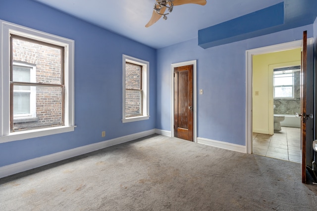 unfurnished room featuring light carpet and ceiling fan