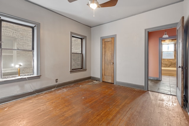 unfurnished bedroom with ceiling fan and hardwood / wood-style floors