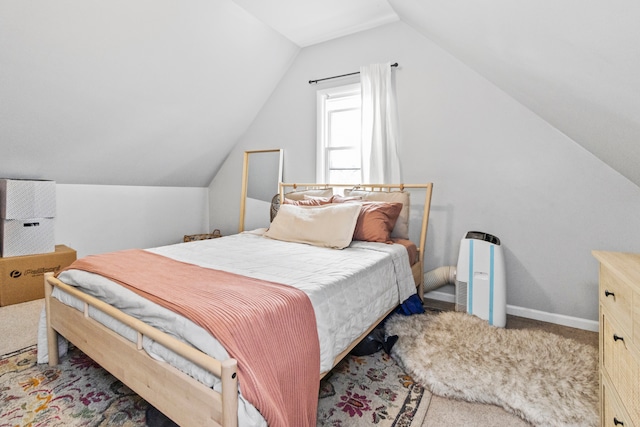 carpeted bedroom with lofted ceiling