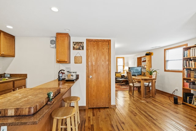 kitchen with a breakfast bar area and light wood-type flooring