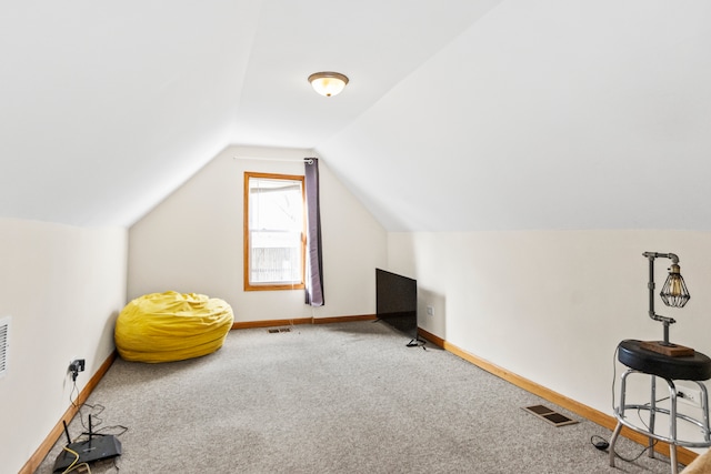 bonus room with carpet flooring and lofted ceiling