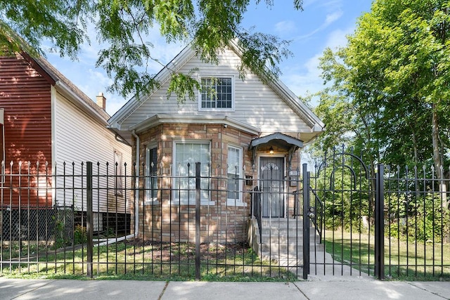 9208 S Dobson Ave, Chicago, IL 60619 - view of front facade with a fenced front yard, a gate, and stone siding