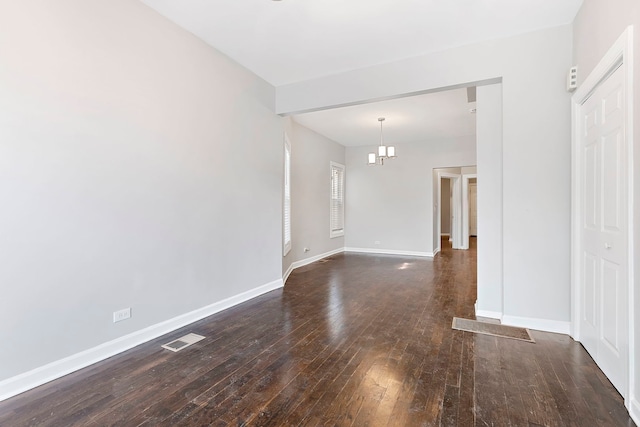 empty room with dark hardwood / wood-style floors