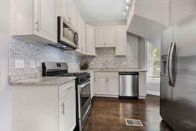 9208 S Dobson Ave, Chicago, IL 60619 - kitchen featuring visible vents, a sink, stainless steel appliances, white cabinets, and dark wood-style floors