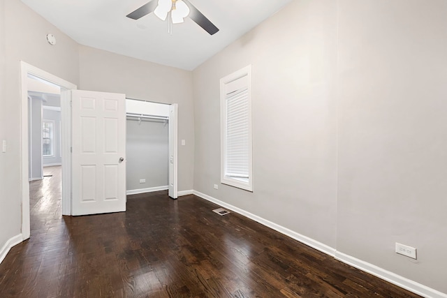 unfurnished bedroom with ceiling fan and dark hardwood / wood-style floors