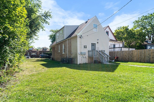 back of property featuring a yard