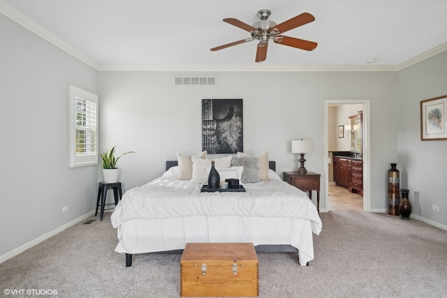 bedroom featuring ornamental molding, ensuite bathroom, light colored carpet, and ceiling fan