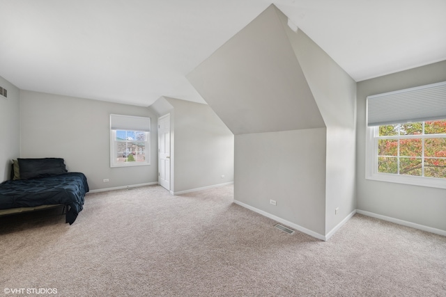 sitting room featuring vaulted ceiling and light colored carpet