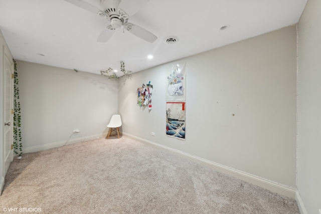 carpeted empty room featuring ceiling fan