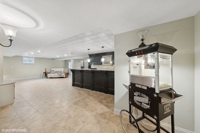 kitchen featuring decorative light fixtures, light stone counters, and light tile patterned floors