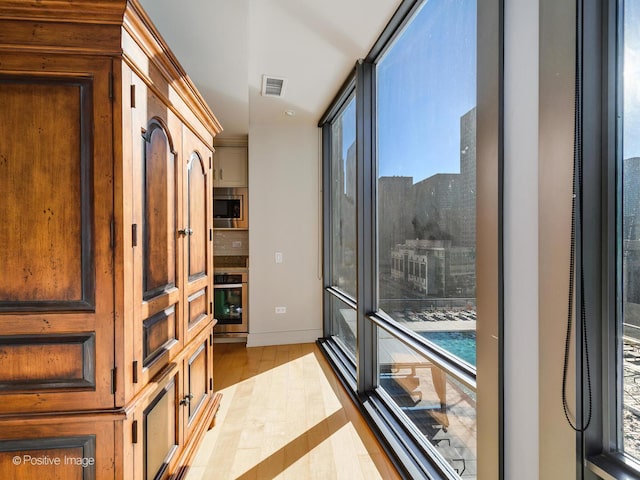 interior space with plenty of natural light and light hardwood / wood-style flooring