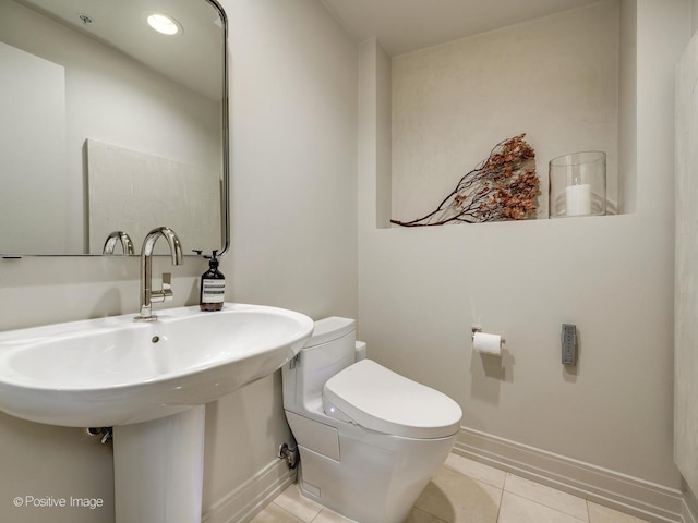 bathroom featuring sink, tile patterned flooring, and toilet