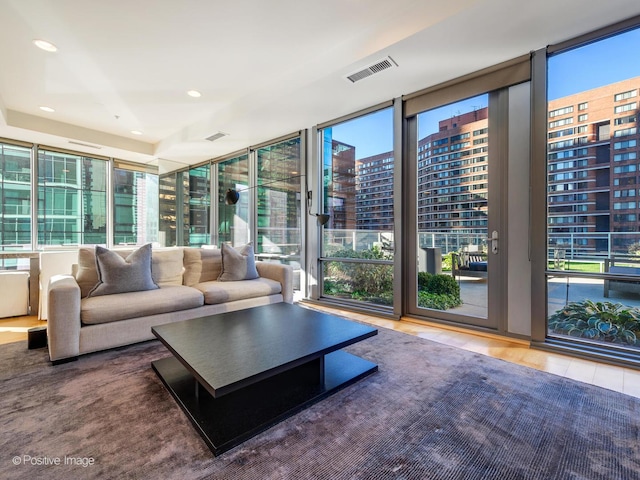 unfurnished living room with hardwood / wood-style flooring and a wall of windows