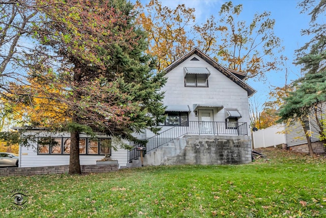 rear view of house featuring a lawn