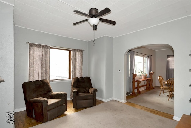 living area with hardwood / wood-style floors and ceiling fan