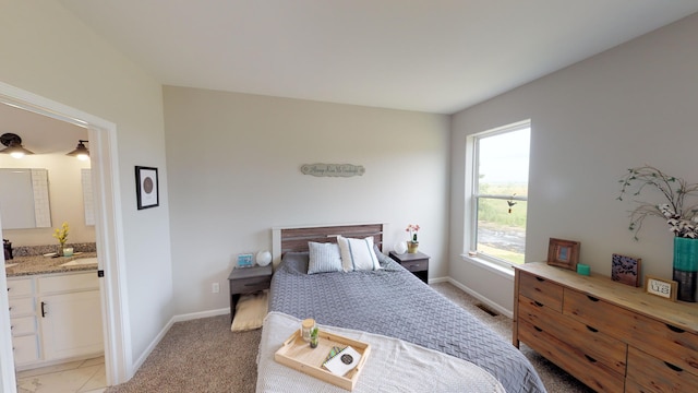 carpeted bedroom featuring ensuite bathroom