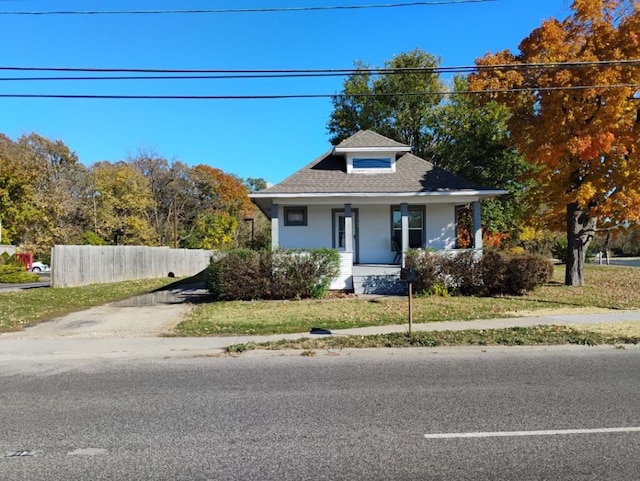 bungalow-style house with a front lawn and a porch