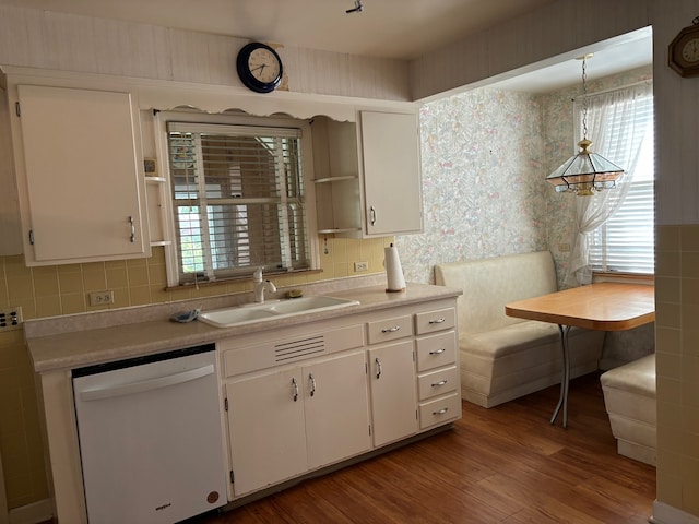 kitchen featuring white cabinetry, white dishwasher, and hanging light fixtures