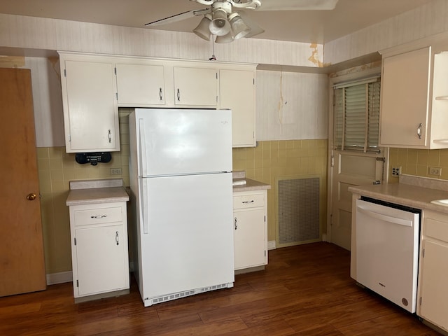 kitchen featuring backsplash, white cabinetry, dark hardwood / wood-style floors, and white appliances