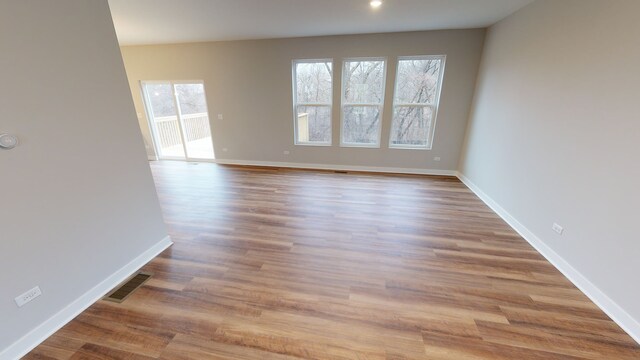 spare room with light hardwood / wood-style floors and a healthy amount of sunlight