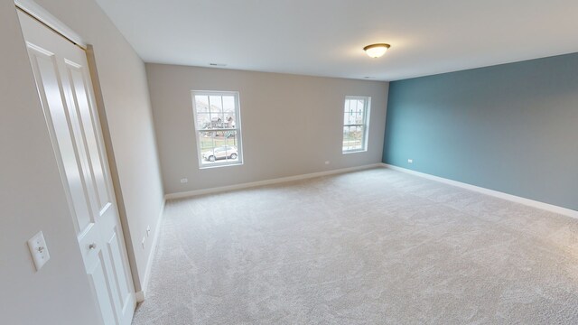 unfurnished room featuring light colored carpet