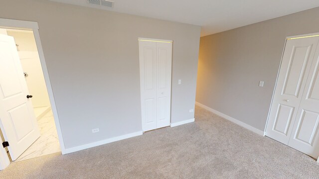 unfurnished bedroom featuring light carpet