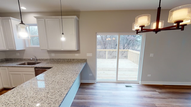 kitchen with sink, white cabinetry, decorative light fixtures, and dark hardwood / wood-style flooring