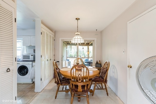 dining space featuring washer / clothes dryer and light tile patterned flooring