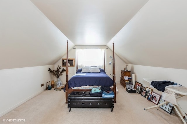 bedroom with a wall mounted AC, vaulted ceiling, and carpet floors