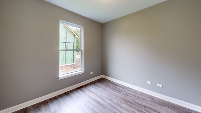 spare room with hardwood / wood-style flooring