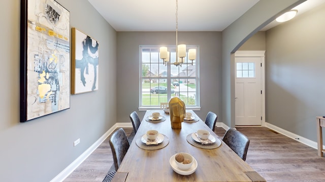 dining space featuring an inviting chandelier and hardwood / wood-style floors