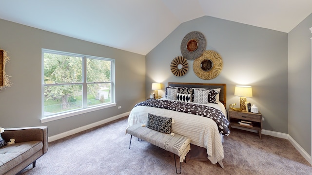 bedroom featuring vaulted ceiling, carpet flooring, and multiple windows