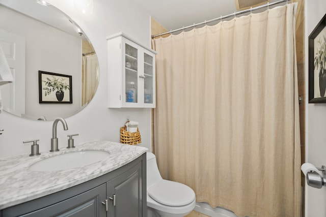 bathroom with vanity, toilet, and a shower with curtain