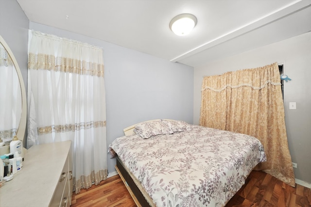 bedroom with dark wood-type flooring