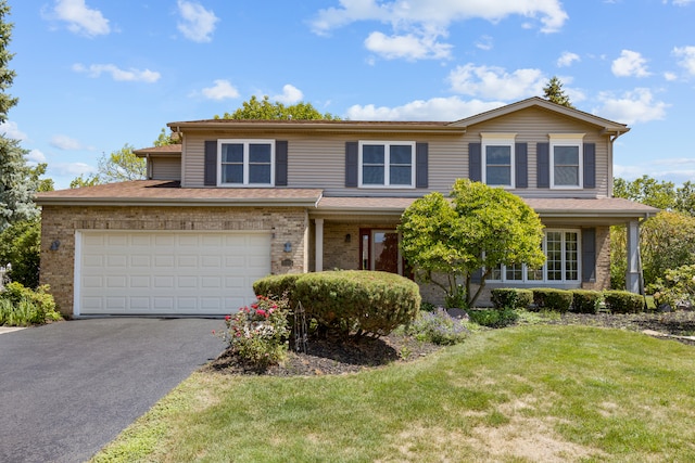 view of property with a front yard and a garage