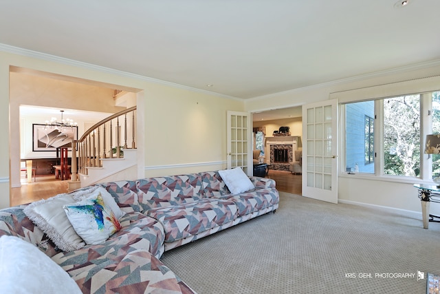 living room with french doors, carpet, a notable chandelier, and ornamental molding