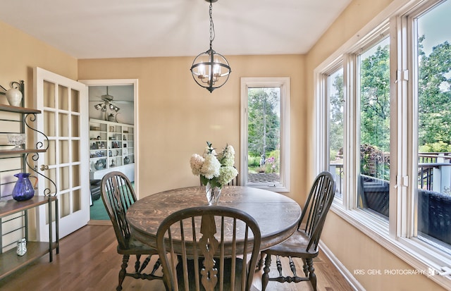 dining space featuring a notable chandelier and dark wood-type flooring