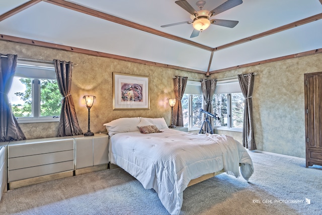 bedroom featuring lofted ceiling, crown molding, light carpet, and ceiling fan