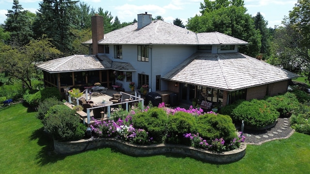 rear view of property with a lawn