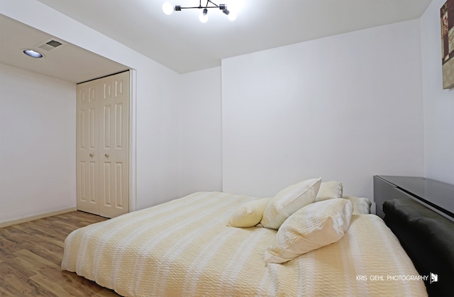 bedroom with hardwood / wood-style flooring and a closet