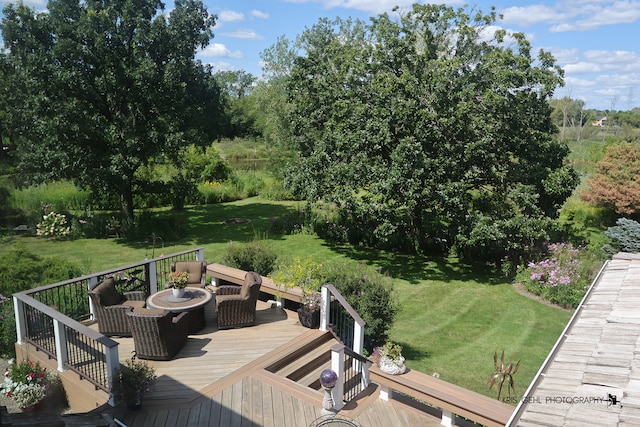 wooden deck with a yard and an outdoor fire pit