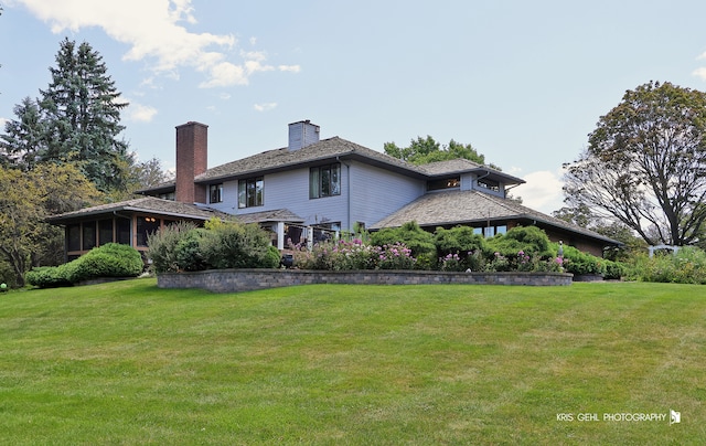 rear view of property featuring a yard